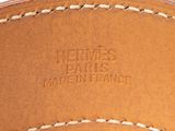 a close up of a brown leather belt with white stitching