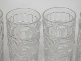 four glasses sitting next to each other on a table