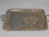 an antique silver tray with handles and handles on a table