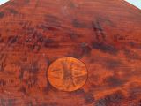 a wooden table with a round top and a wooden base