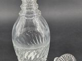 an old glass bottle with a stopper next to it on a table