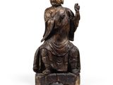 statue d'un Bouddha assis, la main levée