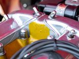 a close up view of a motorcycle engine with a hose
