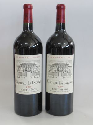 two bottles of red wine sitting next to each other on a table