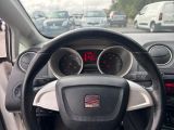 a steering wheel and dashboard of a car in a parking lot