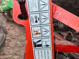 a close up of a red machine with a sticker on it