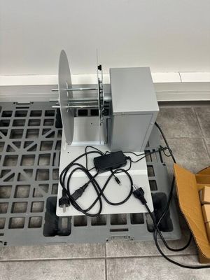 a machine that is sitting on the floor next to a box
