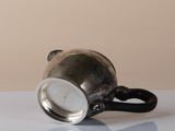 a silver cup that is sitting on a table