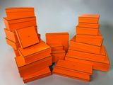 several orange boxes stacked on top of each other on a table