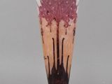 a glass vase with a pink flower inside of it