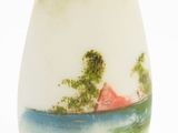 a white vase with a picture of a house on it