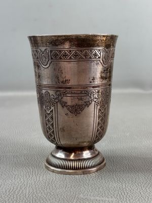 a silver cup that is sitting on a table