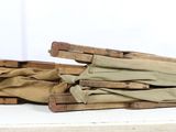 several pieces of wood are stacked on top of each other on a white surface