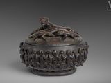 an image of a bronze box with figures on top of it