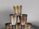 six silver cups are stacked on top of each other on a table