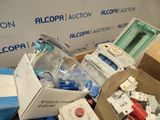 a pile of assorted electronics and other items in a box