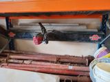 a pipe that is attached to a shelf in a garage