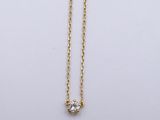 a gold chain with a single diamond on it