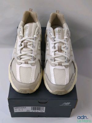 a pair of white sneakers are sitting on a box