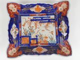 a blue and red plate with a picture on it