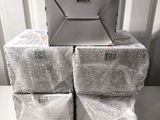 a laptop sitting on top of a stack of packages