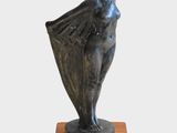 statue of a woman holding a umbrella on a wooden base