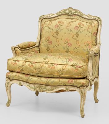 an old fashioned chair with a floral upholstered back