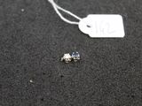 a small piece of jewelry that is on the ground