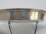 an image of a close up of a silver plate on a stand
