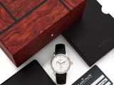 un gros plan sur une montre, un portefeuille et une carte bancaire posés sur une table