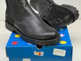 the children ' s black boots are sitting on top of a blue box