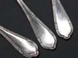 three spoons that are sitting on a table
