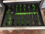 a tool drawer with tools inside of it in a garage