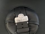 a black suitcase with a black strap and a silver watch on it