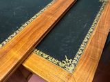 two tables that have black and gold designs on them