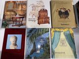 several books are sitting on a table in front of a mirror