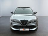 the front view of a silver car in a room with a white wall