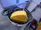a bucket with a yellow object in it sitting on the floor