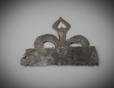 a metal object with horns on it on a white surface