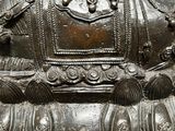 a statue of a woman sitting on top of a horse