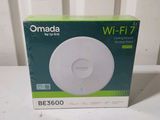 packaging of a white wireless device sitting on top of a white table