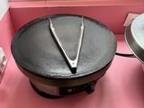 two pans sitting on a pink counter in the kitchen