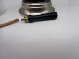 a small lamp that is on a table next to a glass