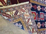 several rugs of different colors and sizes on a carpet