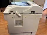 a white printer sitting on top of a box on the floor
