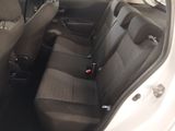 the back seats of a car with a bottle of beer in it