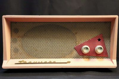 a close up of an old fashioned radio with two eyes on it