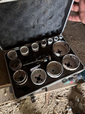 a man holding a tool case with a bunch of holes in it
