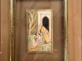 tableau encadré représentant un homme et une femme dans un jardin