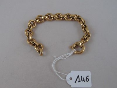 a close up of a gold bracelet with a price tag on it